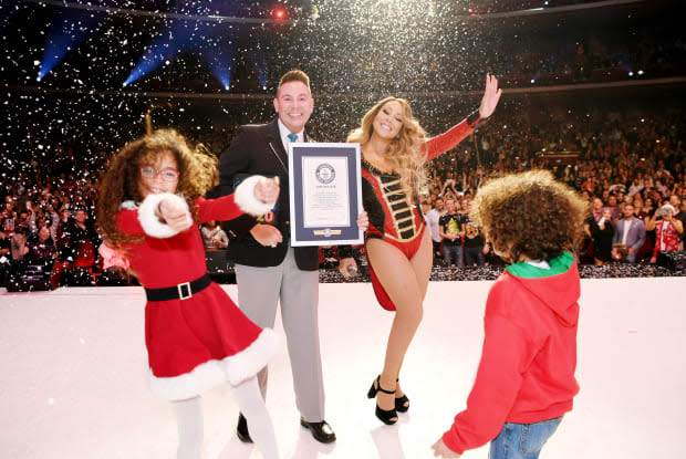 Mariah Carey, accompanied by "Dem Kids" Monroe and Moroccan Cannon, is awarded a Guinness World Record for "All I Want for Christmas Is You" in 2019.<p>Denise Truscello/Getty Images for Caesars Palace</p>