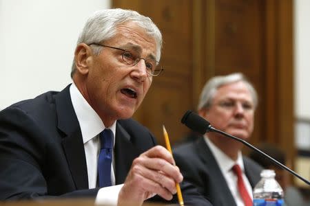 U.S. Defense Secretary Chuck Hagel (L) testifies with Defense Department General Counsel Stephen Preston (R) about the Bergdahl prisoner exchange at a House Armed Services Committee hearing on Capitol Hill in Washington June 11, 2014. REUTERS/Jonathan Ernst