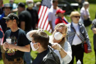Brandi Bates gives Mike Greenbauer a free haircut at the State Capitol during a rally in Lansing, Mich., Wednesday, May 20, 2020. Barbers and hair stylists are protesting the state???s stay-at-home orders, a defiant demonstration that reflects how salons have become a symbol for small businesses that are eager to reopen two months after the COVID-19 pandemic began. (AP Photo/Paul Sancya)