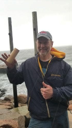 Treasure hunter Eric Jensen holds the bamboo bottle he found on Dec. 23 in Falmouth, in a hole in a rock. The Cape-wide treasure hunt was sponsored by the Whydah Pirate Museum in West Yarmouth and The Brewster Boys.