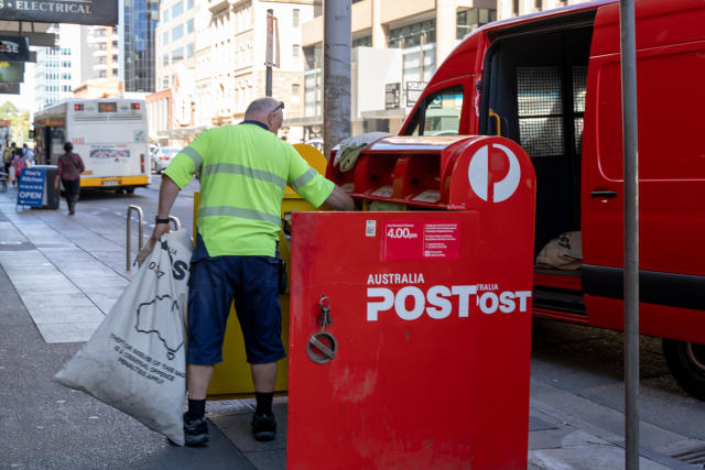 Mail man empties a post box. Source: Getty Images