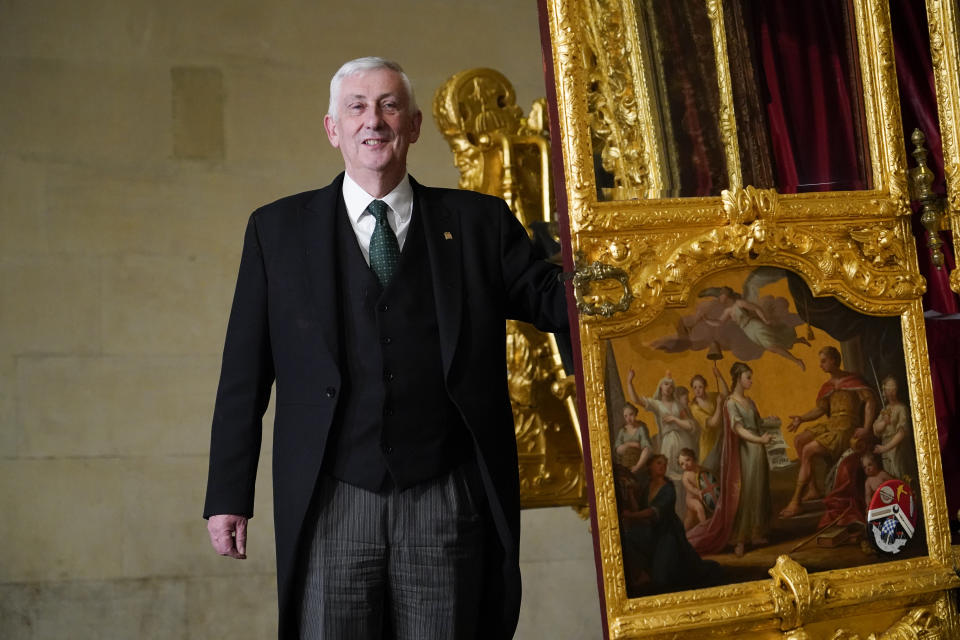 Britain's Speaker of the House of Commons Lindsay Hoyle stands next to the Speaker's State Coach as it returns to Westminster, ahead of the coronation of Britain's King Charles III, in London, Sunday, April 30, 2023. The gilded coach, which was last seen in the historic Westminster Hall in 2005, will be on display once again from 2 May to the Autumn, to commemorate the crowning of King Charles III. (AP Photo/Alberto Pezzali)