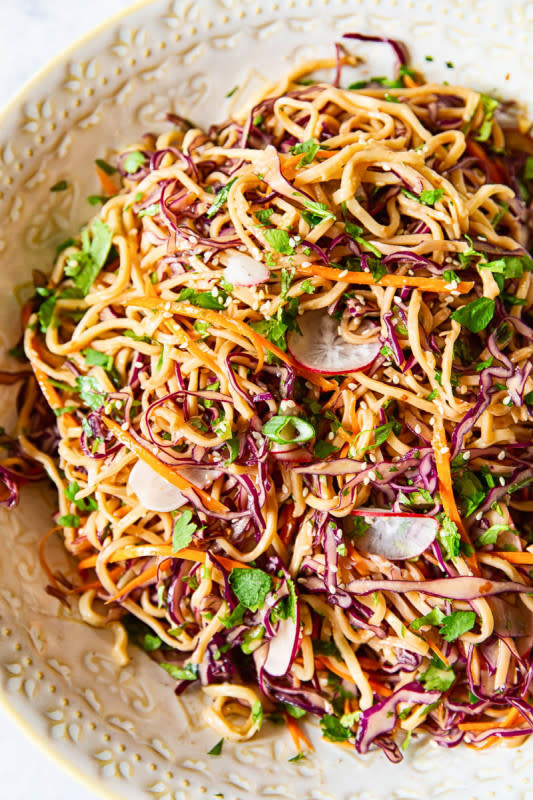 <p>Vikalinka</p><p>This Asian Noodle Salad with thinly sliced red cabbage, julienned carrots and radishes in spicy peanut dressing is ideal for picnics, barbecues or a delicious work lunch.</p><p><strong>Get the Recipe: </strong><a href="https://vikalinka.com/asian-noodle-salad-peanut-dressing/" rel="nofollow noopener" target="_blank" data-ylk="slk:Asian Noodle Salad;elm:context_link;itc:0;sec:content-canvas" class="link rapid-noclick-resp"><strong>Asian Noodle Salad</strong></a></p>