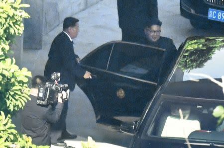 North Korea's leader Kim Jong Un gets into a car as he leaves North Korean embassy in Beijing, China, in this photo taken by Kyodo June 20, 2018. Mandatory credit Kyodo/via REUTERS