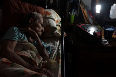Ana Maria Jimenez, 89, lays on a bed after Hurricane Maria destroyed the town's bridge and the surrounding areas, in San Lorenzo, Morovis, Puerto Rico, October 5, 2017. REUTERS/Alvin Baez
