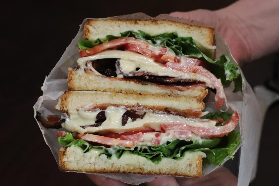 The BLT Grilled Cheese is stacked with Applewood smoked bacon, Cooper sharp cheese, lettuce, tomato, and Rocky's signature garlic Dijon dressing.