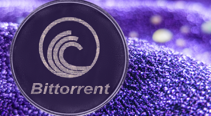 A BitTorrent (BTT) crypto token on a purple fabric background.