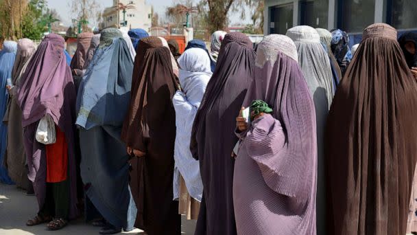 PHOTO: Afghan women stand on a queue to receive food aid distributed by a charity foundation during the Muslim holy fasting month of Ramadan in Kandahar on March 28, 2023. (Sanaullah Seiam/AFP via Getty Images, FILE)