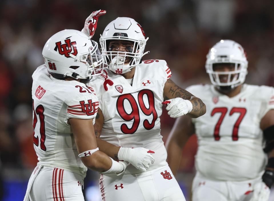 Utah Utes defensive tackle Tevita Fotu (99) is congratulated for breaking up a pass against USC at the Los Angeles Memorial Coliseum on Saturday, Oct. 21, 2023.