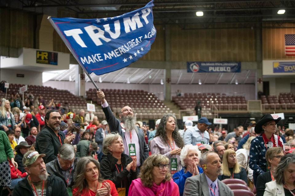 A Colorado Republican delegate waves a Trump flag as Florida Congressman Matt Gaetz delivers the keynote address of the Colorado Republican Party's state assembly at the Southwest Motors Events Center on Saturday, April 6, 2024.