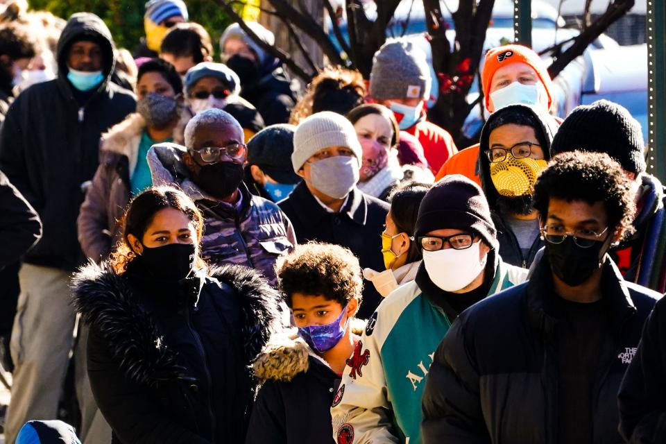 City residents wait in a line extending around the block to receive free at-home rapid COVID-19 test kits in Philadelphia, Monday, Dec. 20, 2021. Philadelphia is ending its indoor mask mandate, city health officials said Thursday night, April 21, 2022, abruptly reversing course just days after city residents had to start wearing masks again amid a sharp increase in infections.(AP Photo/Matt Rourke, File)