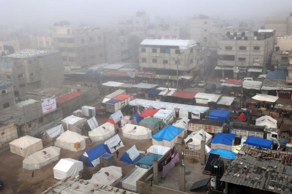 Fog covers buildings and tents set up by displaced Palestinians in Rafah in the southern Gaza Strip on Feb. 25, 2024, amid continuing battles between Israel and the Palestinian militant group Hamas.