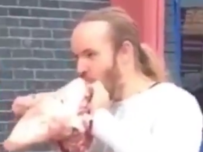 Man eats raw pig’s head outside vegan festival in ‘protest’