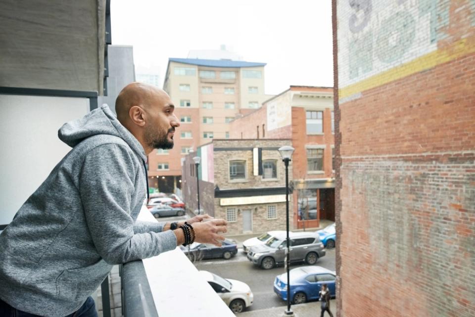 Man looking over balcony