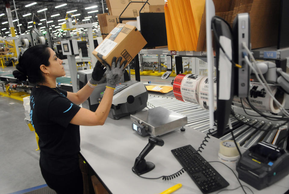 An Amazon associate processes a package for delivery at an Amazon Robotics fulfillment center during its first public tour on April 12, 2019 in the Lake Nona community of Orlando, Florida. The over 855,000 square foot facility opened on August 26, 2018 and employs more than 1500 full-time associates who pick, pack, and ship customer orders with the assistance of hundreds of robots which can lift as much as 750 pounds and drive 5 feet per second.  (Photo by Paul Hennessy/NurPhoto via Getty Images)