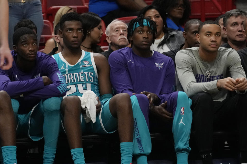 Charlotte Hornets players watch from the bench as they fall behind the Miami Heat during end of the second half of an NBA preseason basketball game, Tuesday, Oct. 10, 2023, in Miami. The Heat defeated the Hornets 113-109. (AP Photo/Marta Lavandier)