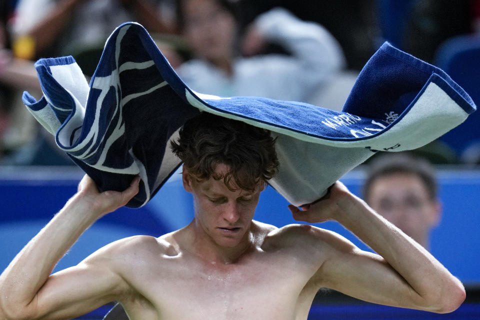 Jannik Sinner of Italy wipes his sweat during a set break in the men's singles match against Tomas Martin Etcheverry of Argentina in the Shanghai Masters tennis tournament at Qizhong Forest Sports City Tennis Center in Shanghai, China, Sunday, Oct. 6, 2024. (AP Photo/Andy Wong)