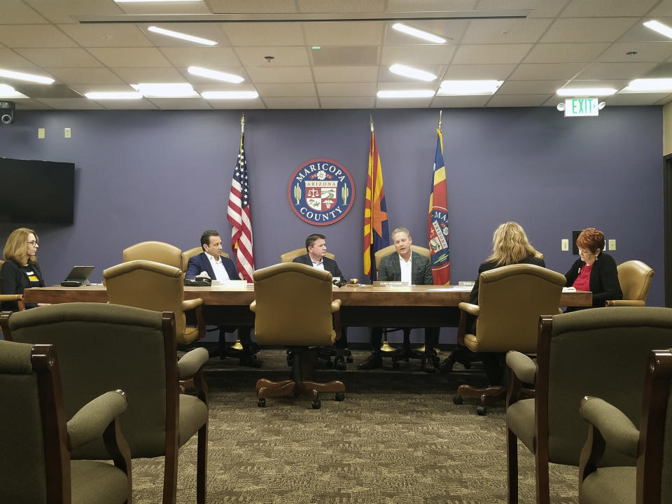 The Maricopa County Board of Supervisors meets in Phoenix on Friday, Dec. 27, 2019. The board on Friday unanimously voted to uphold the suspension of County Assessor Paul Petersen and push for his removal from office. Petersen has pleaded not guilty in Arizona, Arkansas and Utah to charges involving the adoption of babies from the Marshall Islands through his law firm. (AP Photo/Terry Tang)