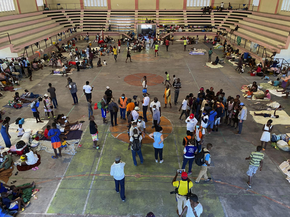 In this handout released Tuesday, June 15, 2021 by UNHaiti, internally displaced people gather inside a shelter at the Center Sportif of Carrefour in Port-au-Prince, Haiti, Tuesday, June 8, 2021. A UNICEF report says that escalating gang violence has displaced thousands of women and children in the capital in the first two weeks of June. (Boulet-Groulx/UNHaiti via AP)