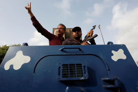 Waseem Akhtar, mayor nominee of Muttahida Qaumi Movement MQM, gestures from an armoured personal carrier while being taken to jail after his arrest from Anti Terrorism Court ATC, in Karachi, Pakistan, July 19, 2016. REUTERS/Akhtar Soomro/File Photo