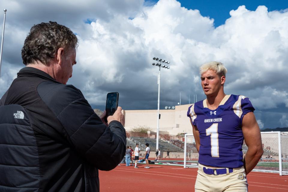 Queen Creek High School's Tait Reynolds does a short interview with recruiting analyst Tom Lemming at the Desert Mountain High School football field on April 1, 2024, in Scottsdale.