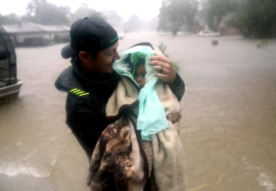 An infant is evacuated from a home in Houston on Monday. The Texas Diaper Bank is raising funds to help families with small children. (Photo: Joe Raedle/Getty Images)