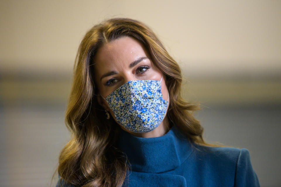 The Duchess of Cambridge recycled a blue Catherine Walking coat that matched her floral face mask. (Getty Images)  