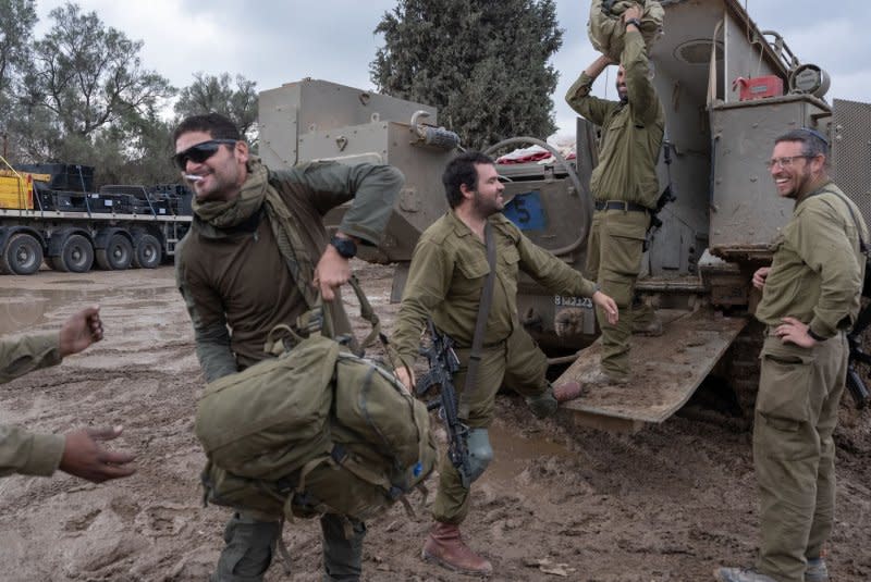 Israeli IDF reserve infantry soldiers remove their gear from an APC (Armored Personnel Carrier) as they return to a southern Israeli staging area from fighting inside the Gaza Strip on Thursday. Photo by Jim Hollander/UPI