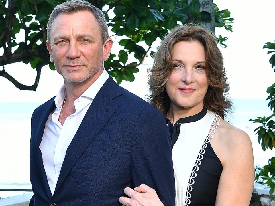 Barbara Broccoli with her arm holding Daniel Craig