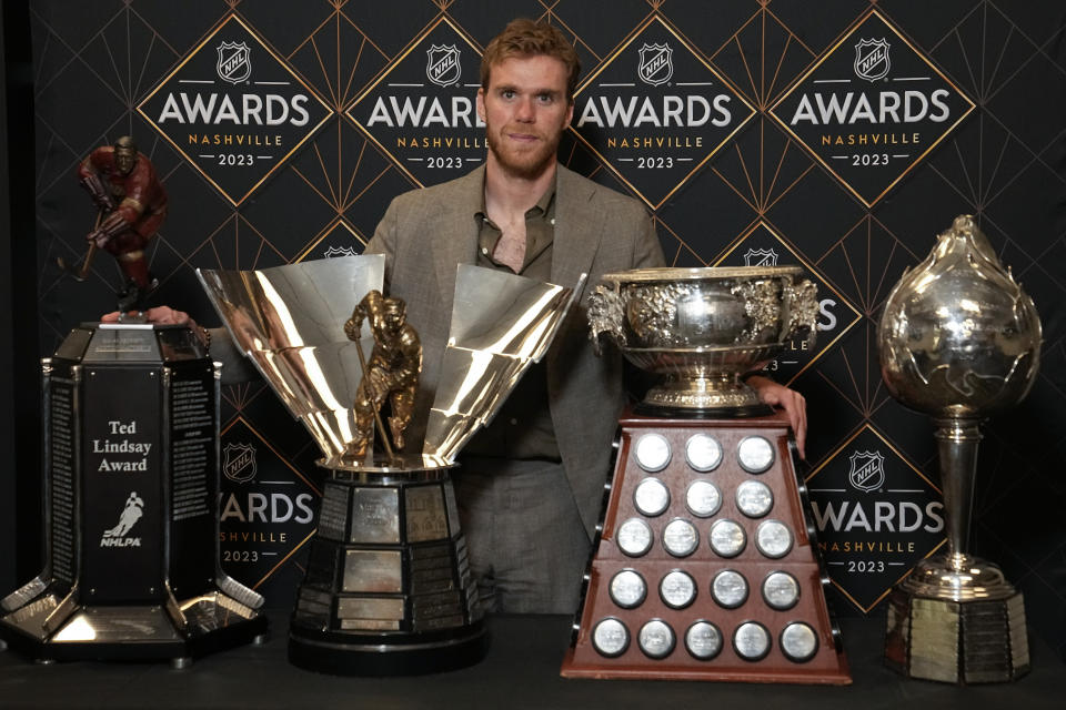 Edmonton Oilers hockey player Connor McDavid poses with the Ted Lindsey Award, the Maurice "Rocket" Richard Trophy, the Art Ross Trophy and the Hart Memorial Trophy at the NHL Awards, Monday, June 26, 2023, in Nashville, Tenn. (AP Photo/George Walker IV)