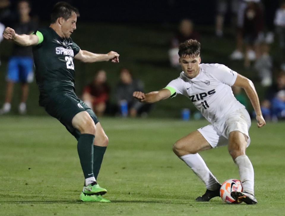 Michigan State University's Louis Sala watches as University of Akron's Will Jackson maneuvers the ball in their men's soccer match in Akron on Monday, Sept. 5. The Zips beat the Spartans 2-0.