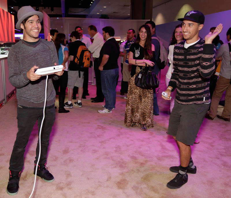 FILE - In this June 7, 2012 publicity file photo provided by Nintendo, Pete Wentz, left, and guests get an exclusive preview of Nintendo's Wii U during E3 in Los Angeles. (AP Photo/Nintendo,Todd Williamson)