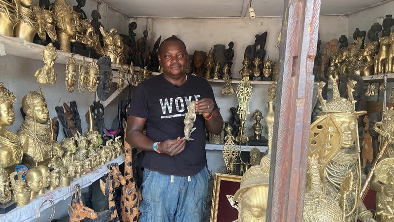 Edosonmwan William, bronze maker is seen with one of his works inside is gallery at Igun street, Benin