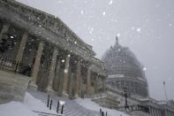 Snow continues to fall outside the U.S. Capitol in Washington January 23, 2016. REUTERS/Jonathan Ernst