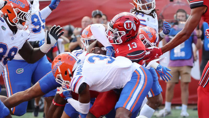 Utah Utes quarterback Nate Johnson (13) scores a touchdown against the Florida Gators in Salt Lake City on Thursday, Aug. 31, 2023 during the season opener. Utah won 24-11.