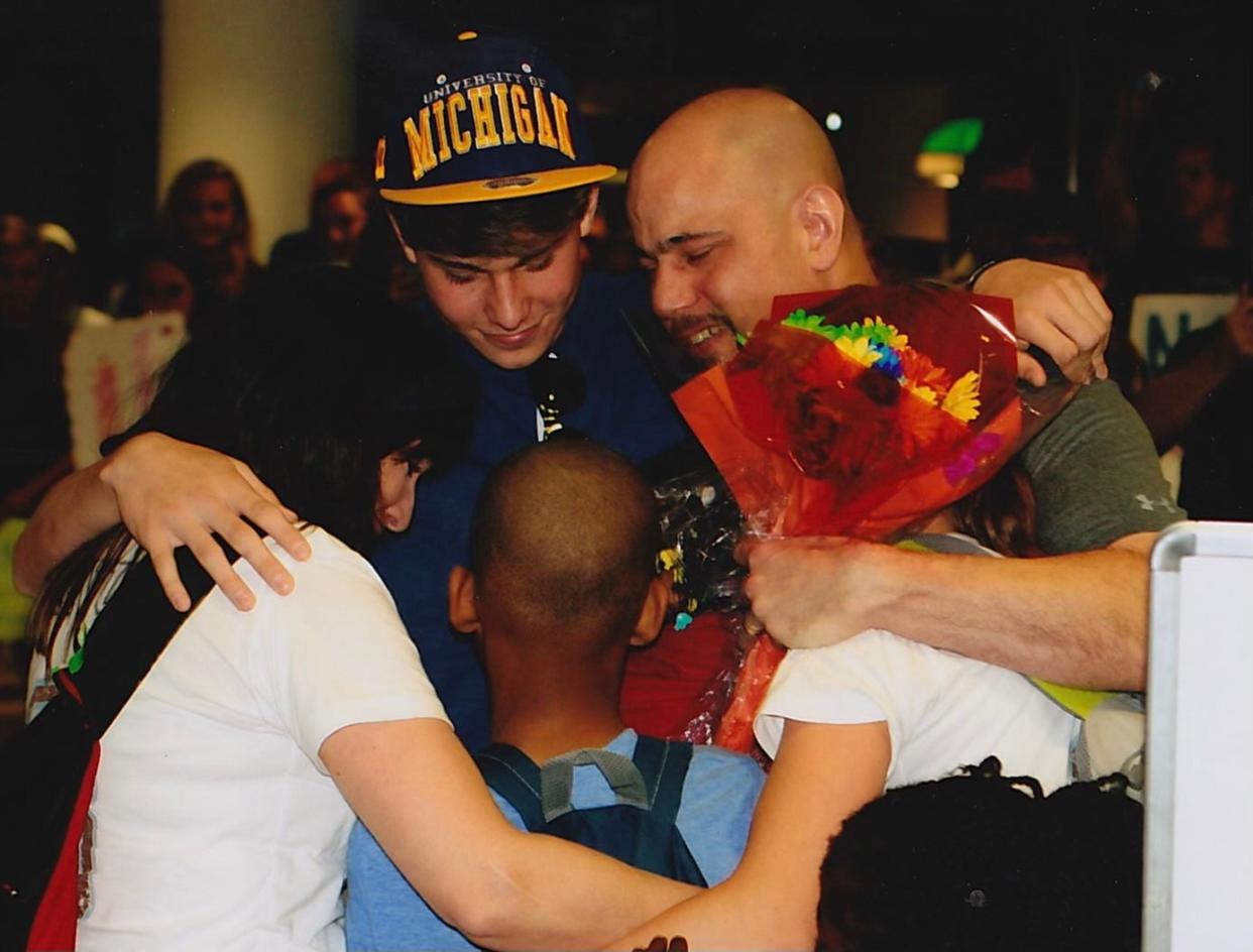 Junior Colson, center front, is surrounded by (left to right) adoptive mom Melanie Colson, brother Joshua, dad Steve and sister Amanda after Junior arrived in America in 2012. The Colsons adopted Junior from a Haiti orphanage after visiting the country following the deadly 2010 earthquake. He became a star linebacker at Ravenwood and Michigan and is a 2024 NFL Draft prospect.