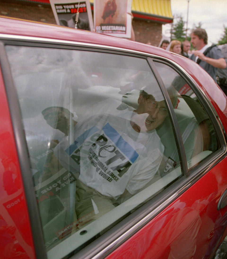 James Cromwell sits in an unmarked police car after being arrested on July 3, 2001, during a demonstration at a Wendy's restaurant in Tysons Corner, Virginia. (Photo: Robert Visser via Getty Images)