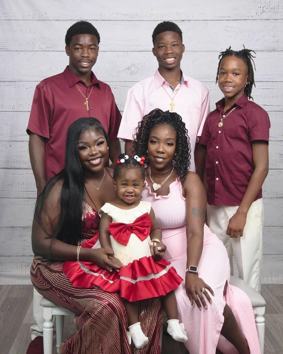 Home Bring Hope client Lillie Lovett, seated at right, is pictured with her family.