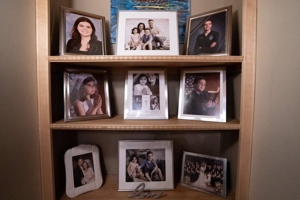 Family photos are displayed in Brenda and Brian Lilly's home, Thursday, Oct. 13, 2022, in Easton, Conn. Brian Lilly Jr., 19, who committed suicide on Jan. 4, 2021, was a rower at University of California San Diego. The Lillys have filed a wrongful death lawsuit against the university and the rowing coach, Geoff Bond, who is no longer with the school. (AP Photo/Julia Nikhinson)