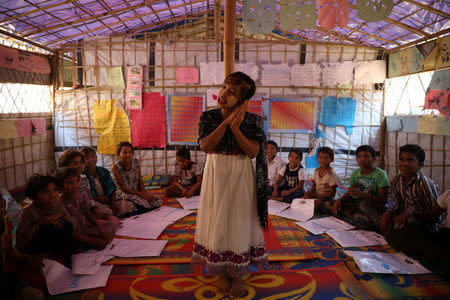 A Rohingya girl acts as she recites a rhyme while attending classes in a learning centre run by UNICEF at Balukhali refugee camp in Cox's Bazar, Bangladesh, January 20, 2018. REUTERS/Mohammad Ponir Hossain