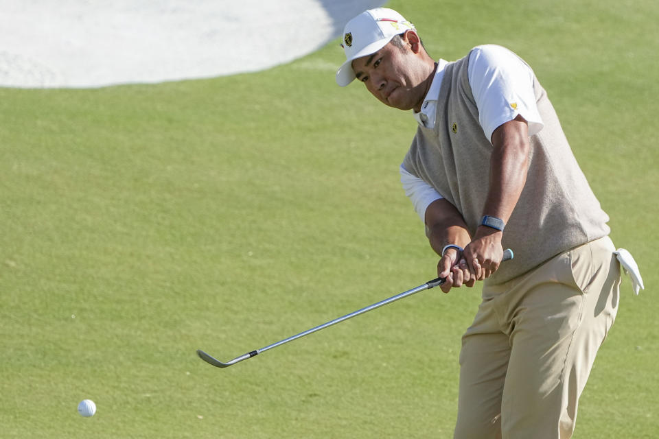 Hideki Matsuyama, of Japan, chips to the 12th green during their foursomes match at the Presidents Cup golf tournament at the Quail Hollow Club, Saturday, Sept. 24, 2022, in Charlotte, N.C. (AP Photo/Chris Carlson)