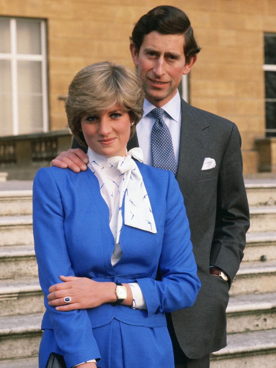 Lady Diana Spencer (later to become Princess of Wales) reveals her sapphire and diamond engagement ring while she and Prince Charles, Prince of Wales pose for photographs in the grounds of Buckingham Palace following the announcement of their engagement