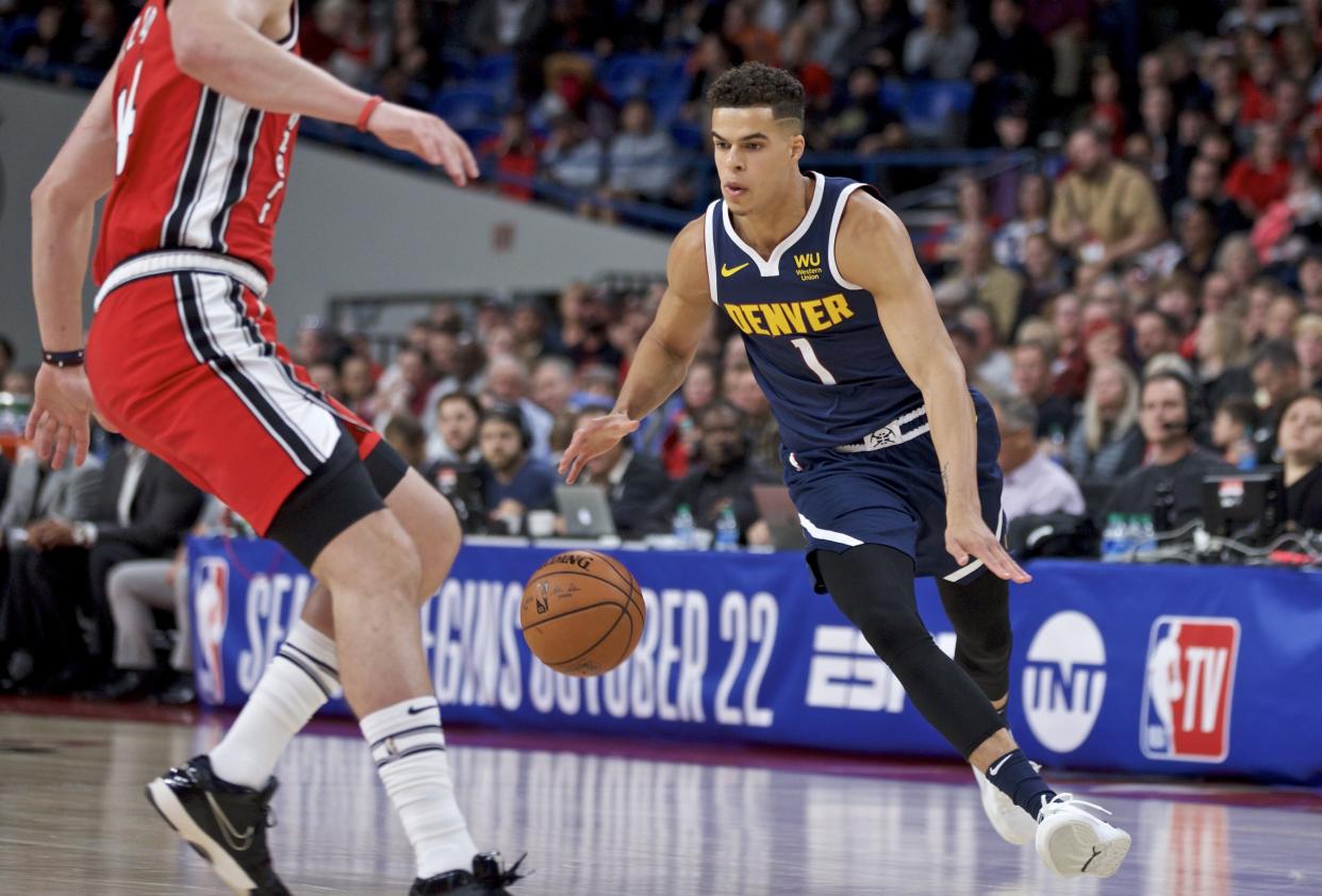 Denver Nuggets forward Michael Porter Jr., right, dribbles toward Portland Trail Blazers forward Mario Hezonja during the second half of a preseason NBA basketball game in Portland, Ore., Tuesday, Oct. 8, 2019. (AP Photo/Craig Mitchelldyer)