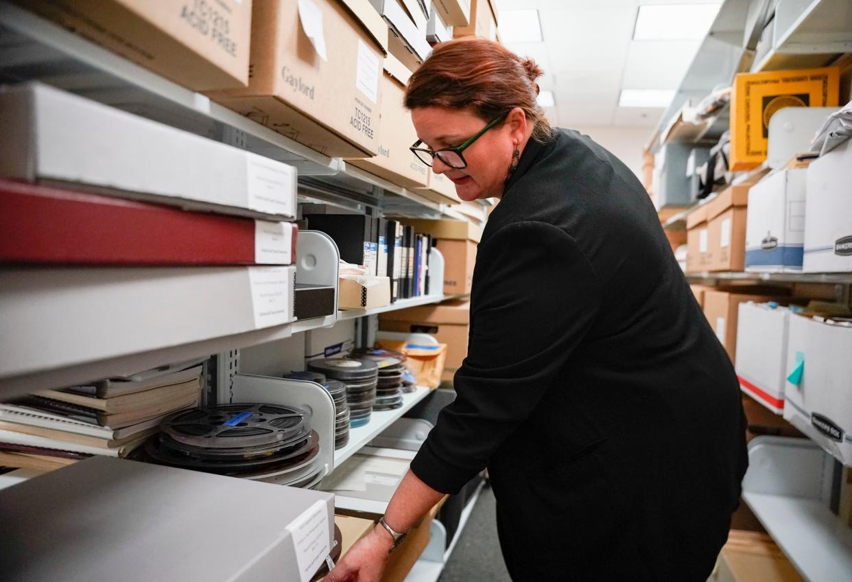 Melissa VandeBurgt, Director for Academic and Community Engagement and Head of University Archives and Special Collections,
looks through old film reels inside the archive at Florida Gulf Coast University's library in Fort Myers on Wednesday, Feb. 22, 2023.
(Photo: Jonah Hinebaugh/Naples Daily News)