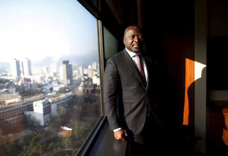 Lassina Zerbo, head of the Comprehensive Nuclear-Test-Ban Treaty Organisation (CTBTO), stands next to a window that overlooks the downtown of Seoul as he pose for photographs during an interview with Reuters at a hotel in Seoul, South Korea, December 7, 2015. REUTERS/Kim Hong-Ji