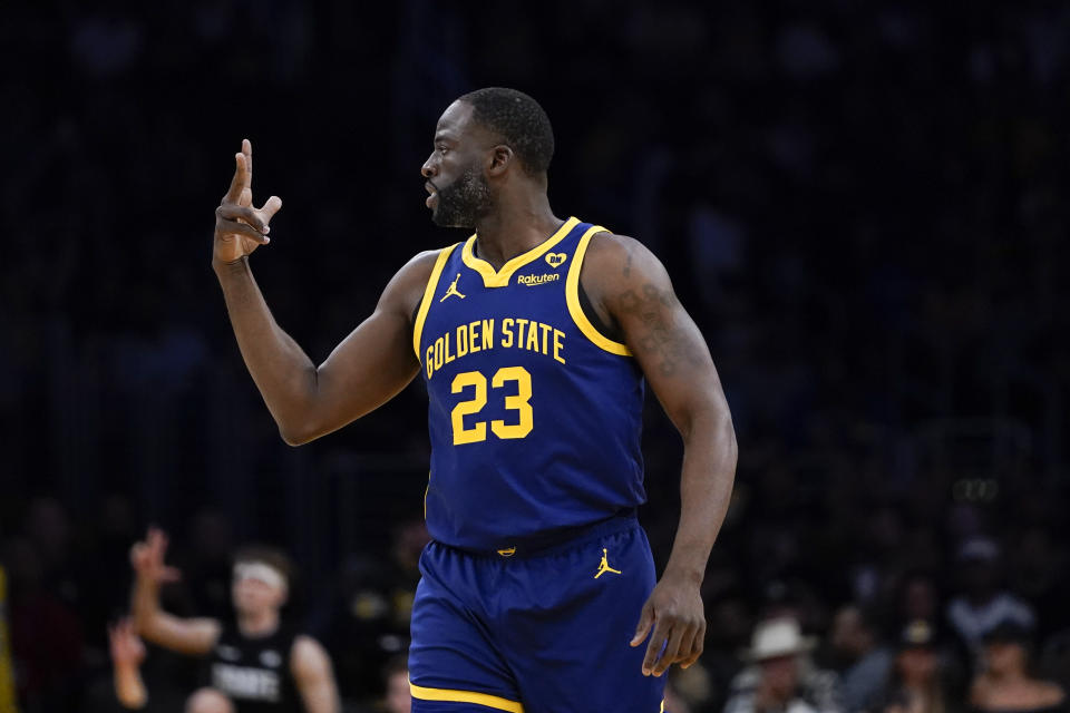 Golden State Warriors forward Draymond Green gestures after a 3-point basket against the Los Angeles Lakers during the first half of an NBA basketball game Tuesday, April 9, 2024, in Los Angeles. (AP Photo/Ryan Sun)