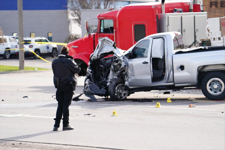 A Macomb County Sheriff's officer investigate a car crash that involved a tractor-trailer and a pickup truck, a man's fatal shooting by Roseville police on Groesbeck Highway, between 12 Mile and Martin roads, on Tuesday, April 26, 2022.