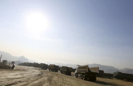 Trucks are seen at a jade stone mine dump at a Hpakant jade mine in Kachin state, Myanmar November 25, 2015. REUTERS/Soe Zeya Tun