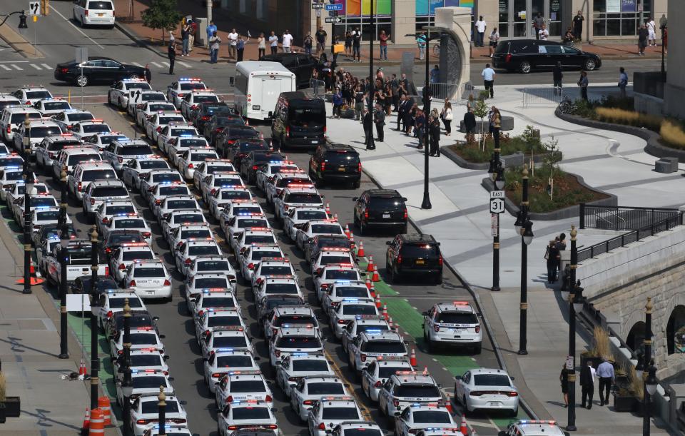 The casket of Rochester Police Officer Anthony Mazurkiewicz is driven down South Avenue as a sea of police cruisers wait to follow the procession following his funeral Monday, Aug. 1, 2022 in downtown Rochester. 