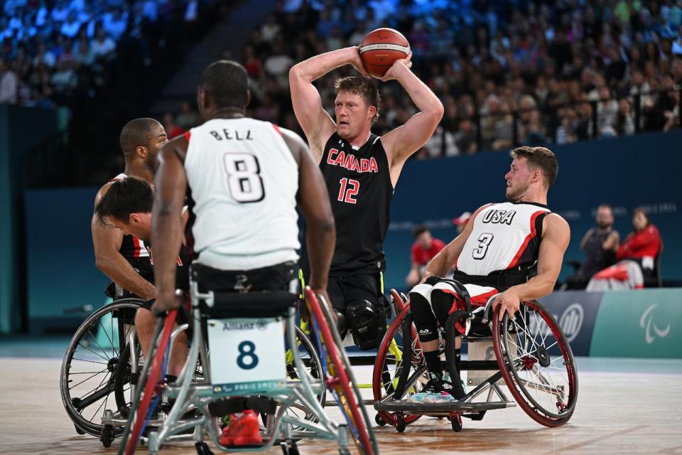 PARIS, FRANCE - SEPTEMBER 05: Patrick Anderson of Team Canada is challanged by Brian Bell and Talen Jourdan of Team United States during the Wheelchair Basketball Mens's Semifinal game 38 between Team United States and Team Canada on day eight of the Paris 2024 Summer Paralympic Games at Bercy Arena on September 05, 2024 in Paris, France. 